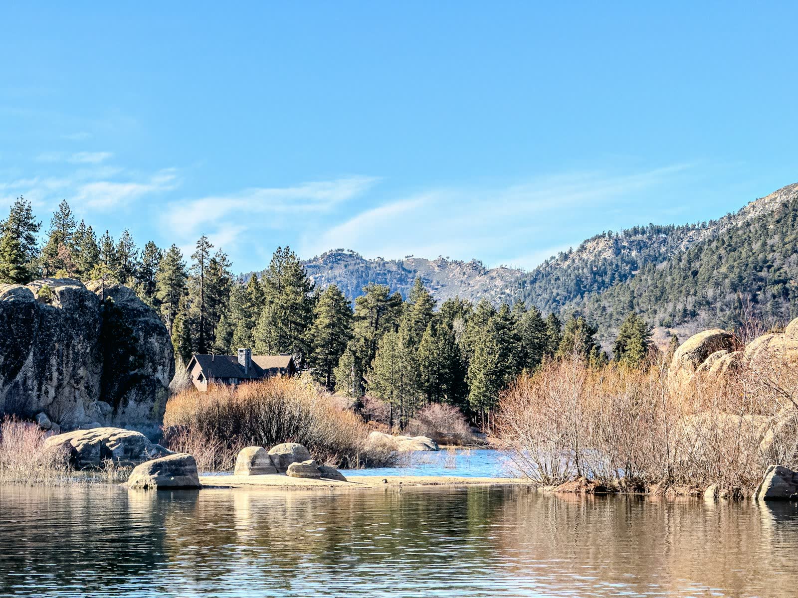 Cabin among boulders and pines on the shore of Big Bear Lake, California