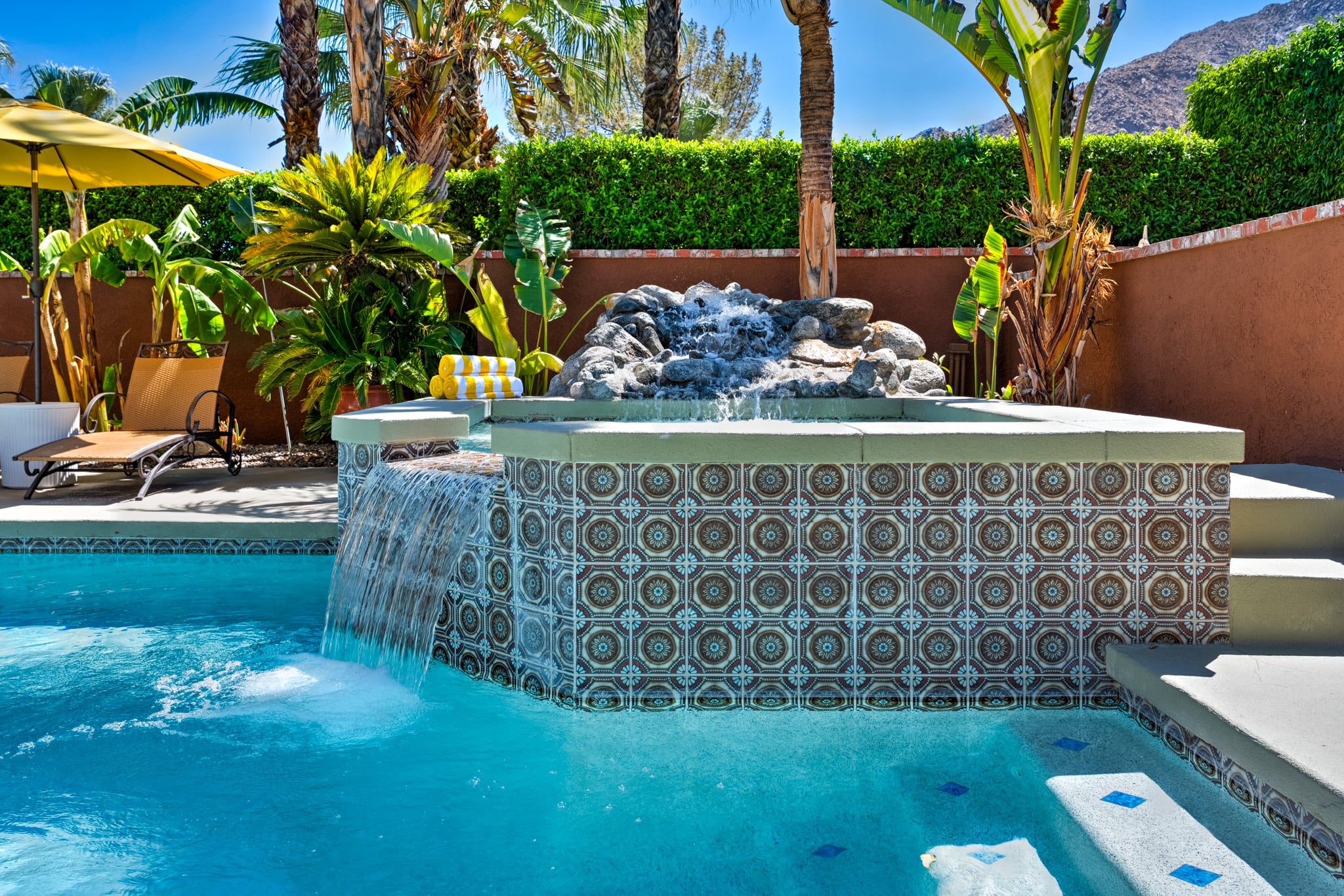 The tiled spa at Mercury Palms with water spilling into the pool