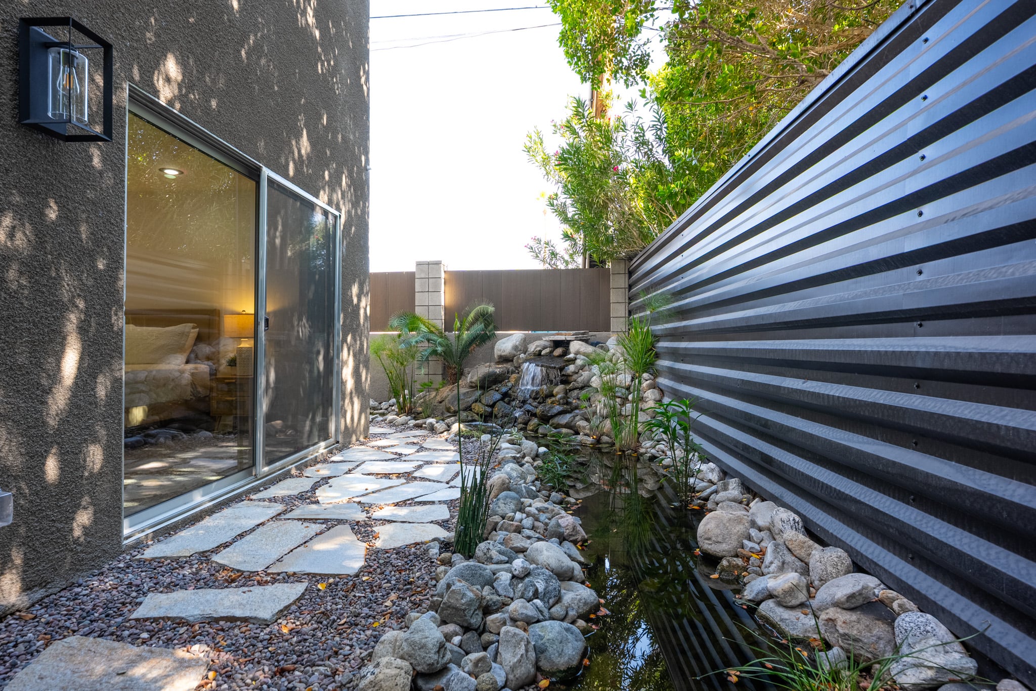 A private yard at Querencia Palms with established planting and a mountain view