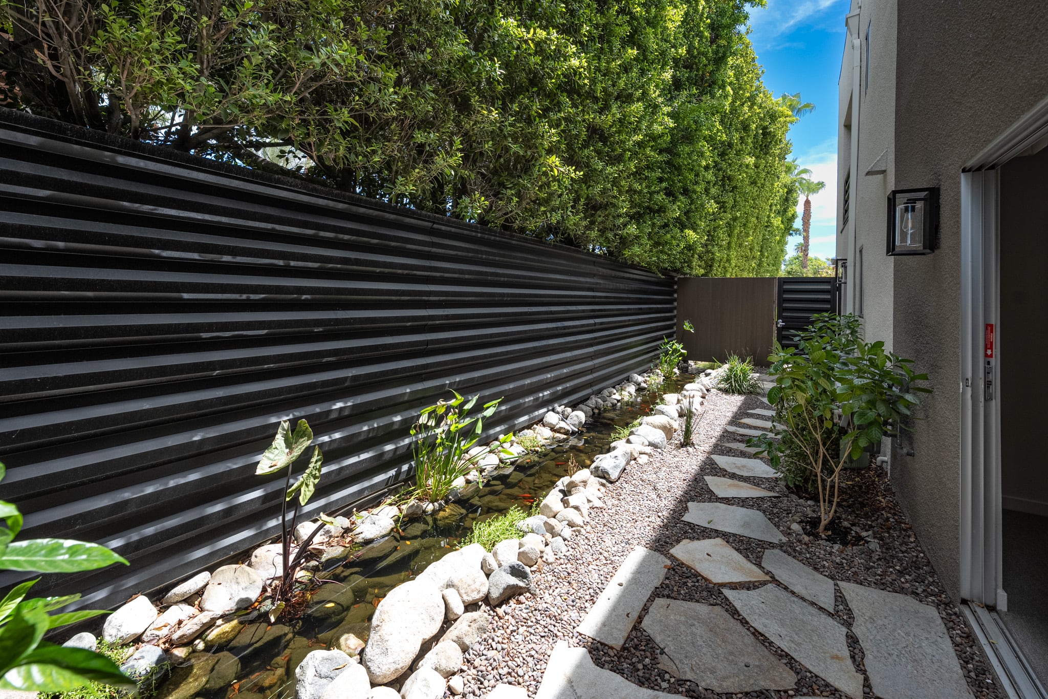 Back patio of Unit 106 after planting, private and green