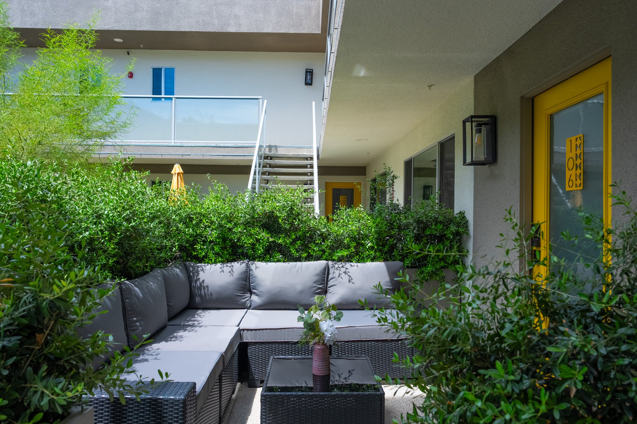 The front patio of a Querencia Palms residence framed by mature planting